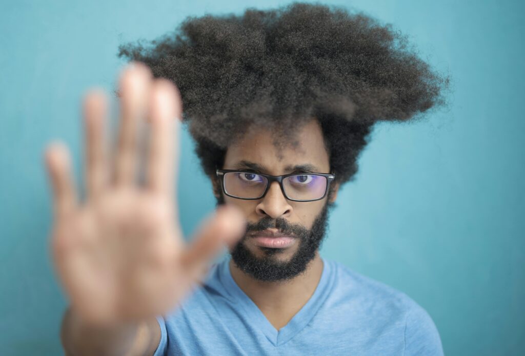 black man holding up his hand signaling stop