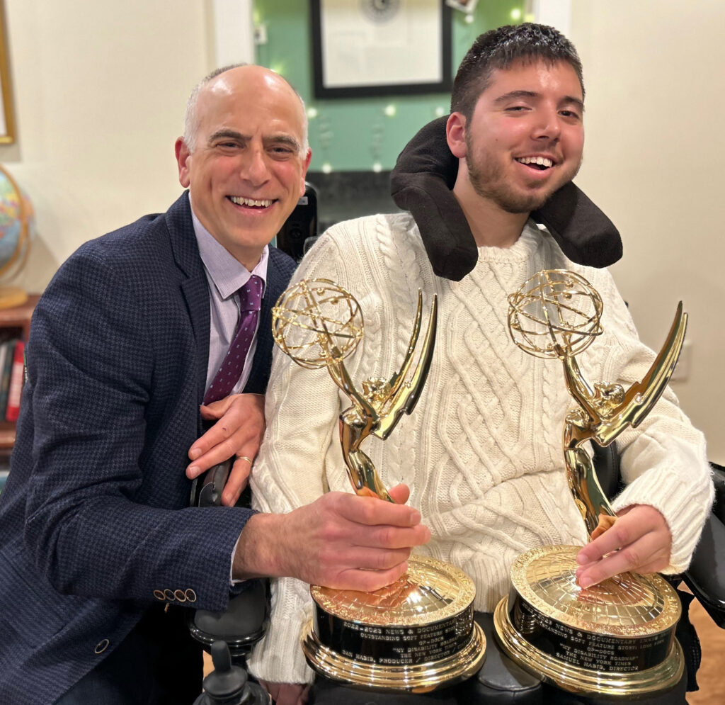 Dan and Samuel Habib side by side, smiling and holding Emmy statuettes, symbolizing their achievement in documentary filmmaking and disability advocacy.