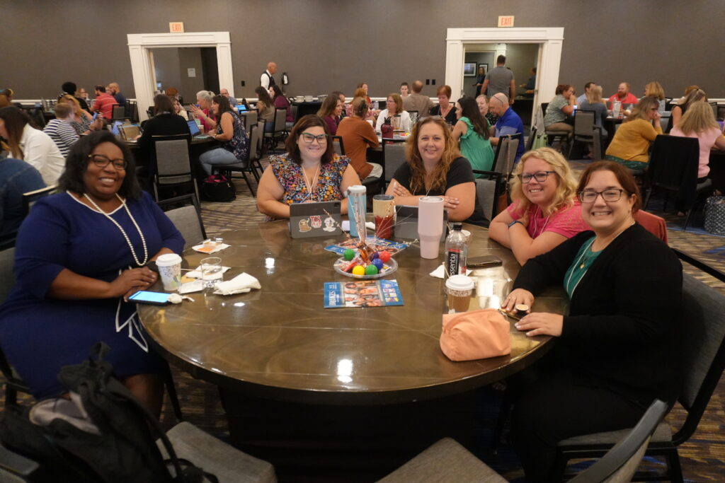 Group sitting at a table during the MCIE Summer Institute 