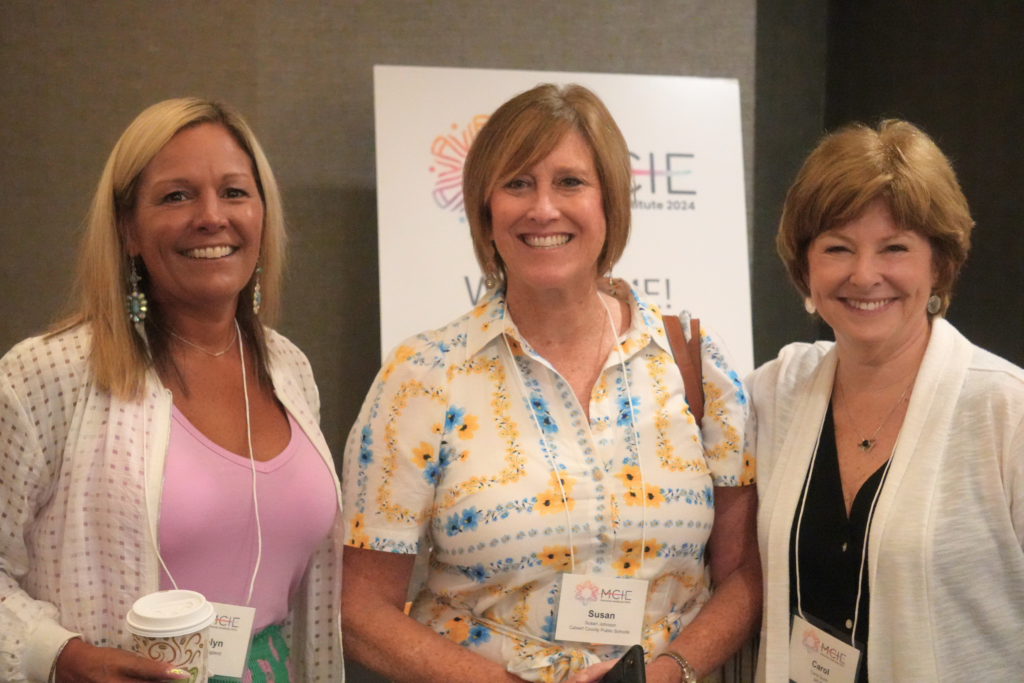 Carolyn, Susan, and Carol posing for a picture during the summer institute