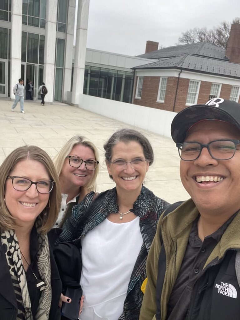 Tim and members of the Terps Exceed team standing in front of a building
