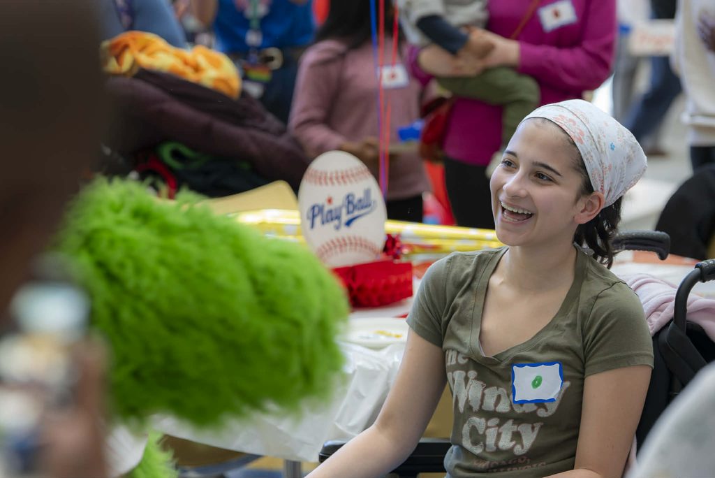 Emma Ruso in a green shirt and white bandana smiling