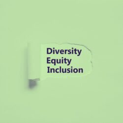 green tinted paper scratched back to reveal the words Diversity, Equity, and Inclusion