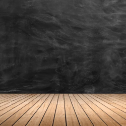 an empty classroom with a wall for a chalkboard